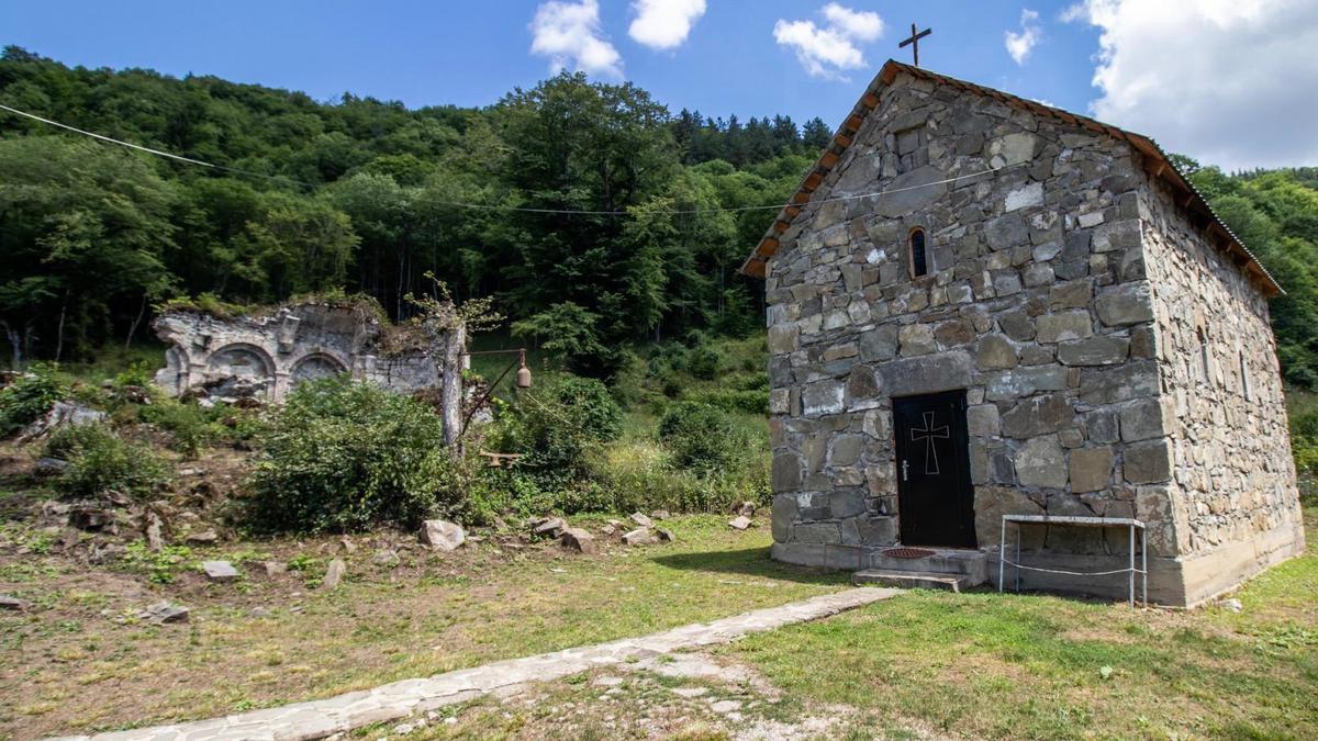 A small gray stone church building