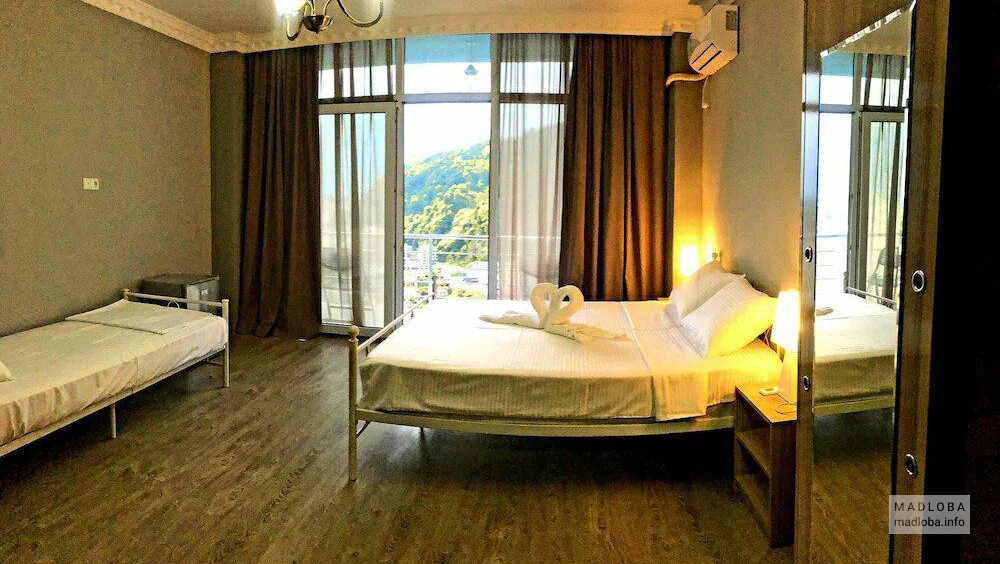 Interior of a bedroom in Calypso Kvariati Hotel