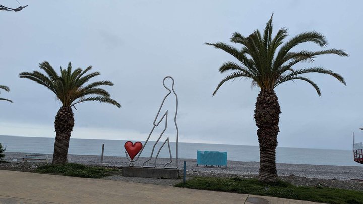 Sculpture "A Man Carrying a Red Heart on a Cart"