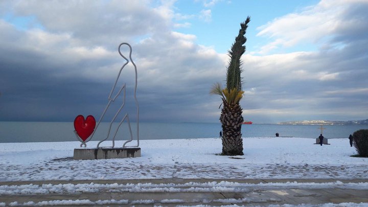 Sculpture "A Man Carrying a Red Heart on a Cart"