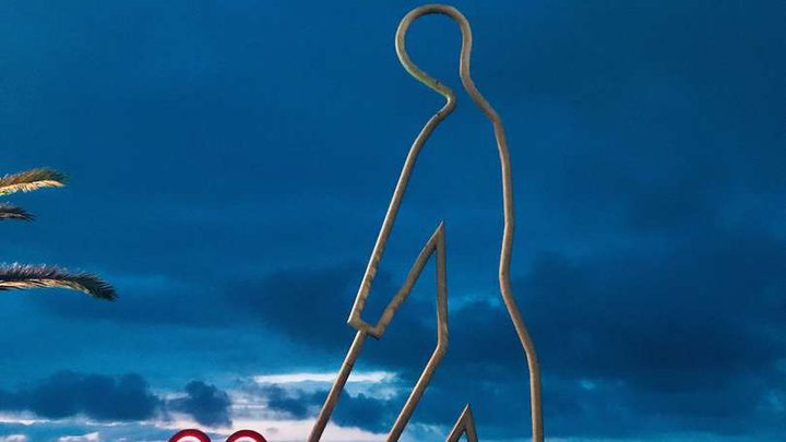 Sculpture "A Man Carrying a Red Heart on a Cart"