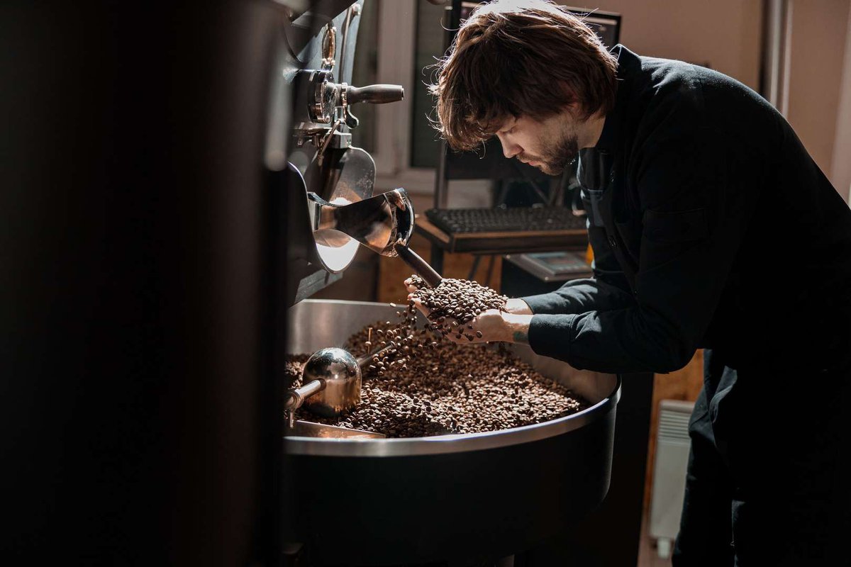 The barista checks the readiness of the coffee bean