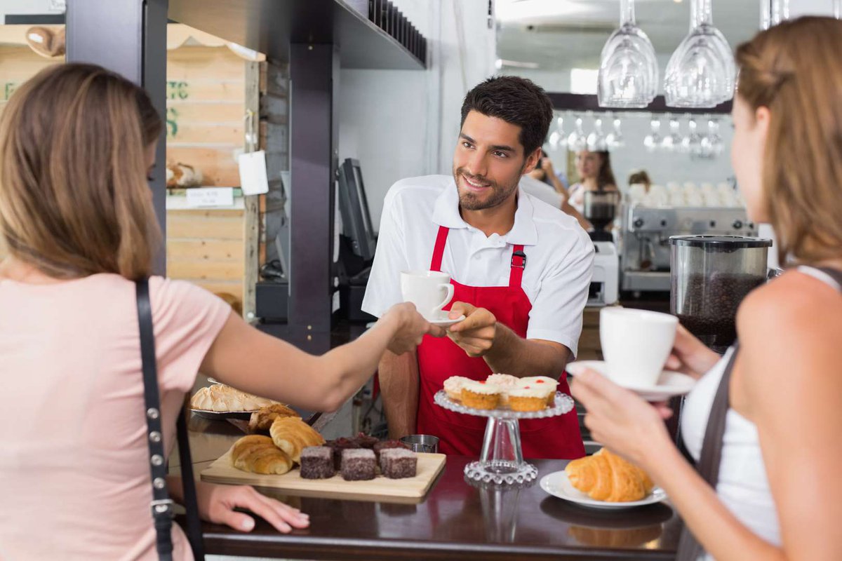Friendly barista and cafe customers