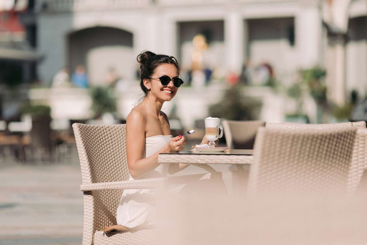 The girl in sunglasses outside the cafe