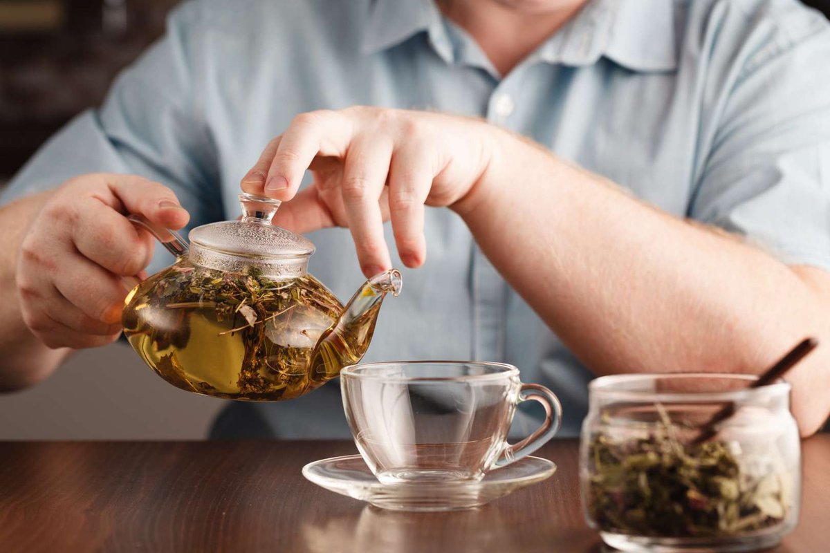 A man pours herbal tea