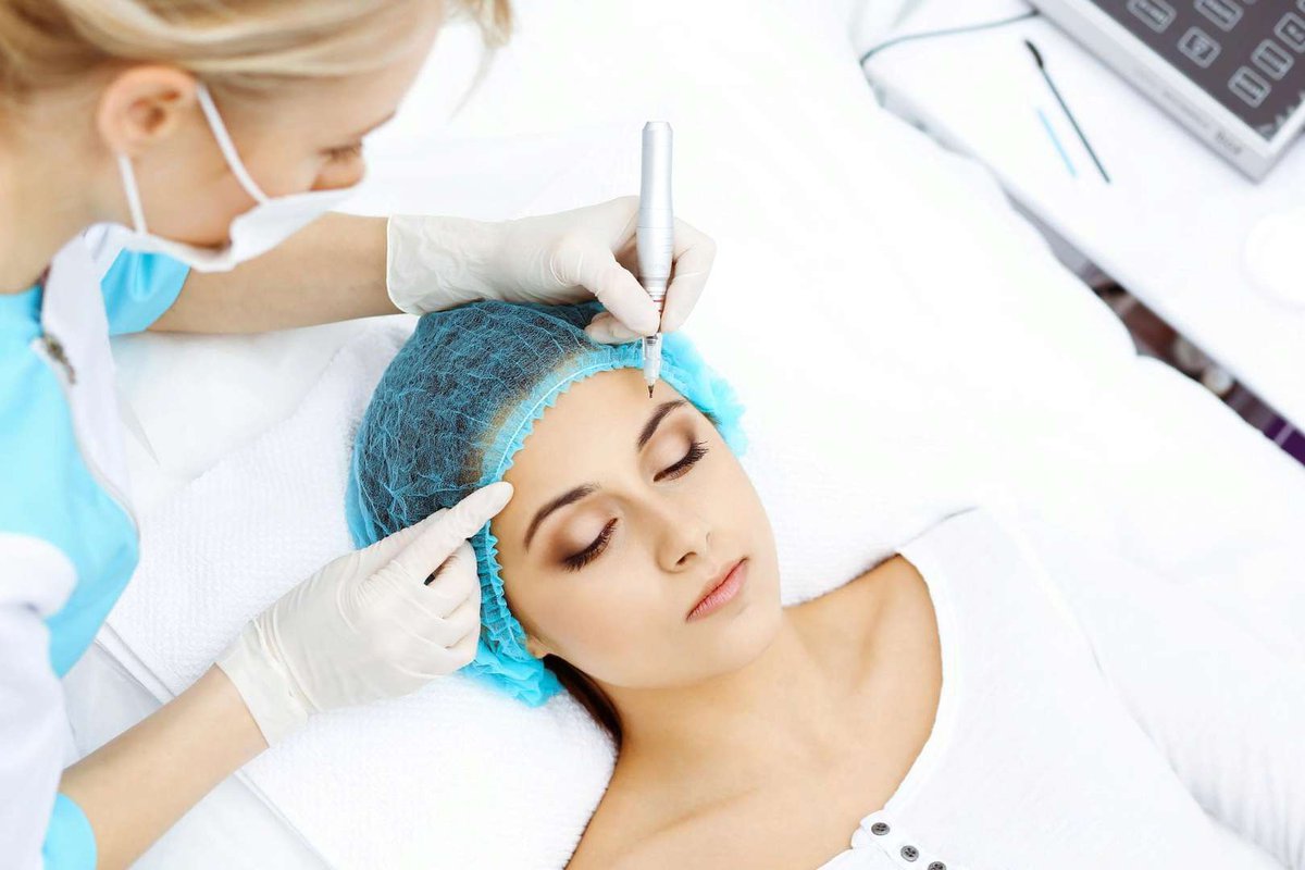 professional-beautician-doing-eyebrow-tattoo-at-woman-face.jpg